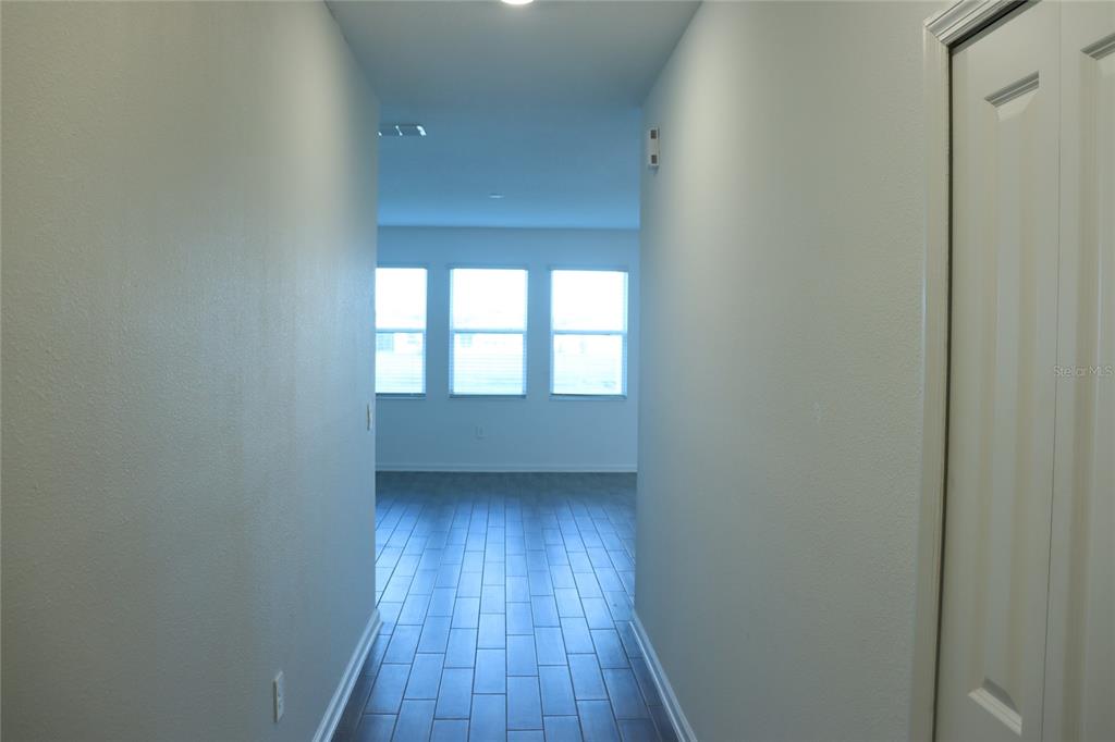 34558 Shellback Street Leesburg, FL 34788 - Photo 24 of 36 a view of an empty room with wooden floor and a window
