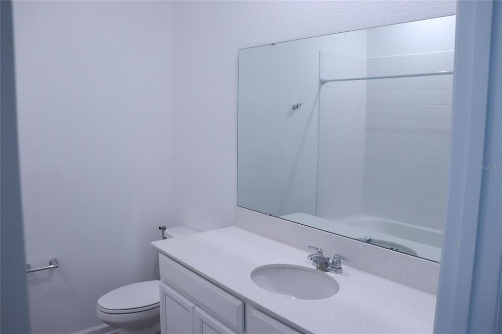 34558 Shellback Street Leesburg, FL 34788 - Photo 30 of 36 a bathroom with a sink and a vanity