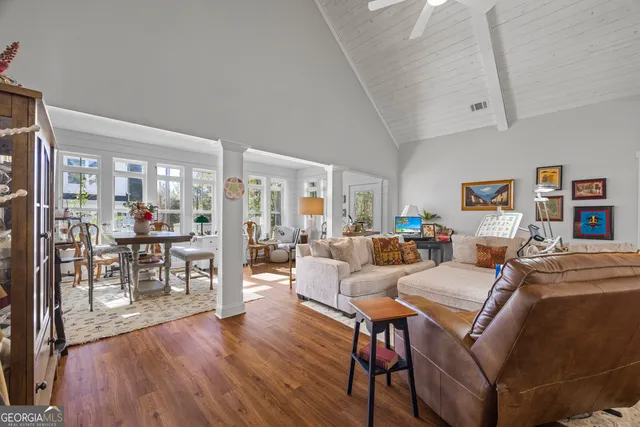a living room with furniture and a dining table