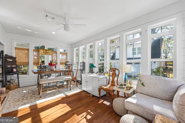 a kitchen with a refrigerator and white cabinets