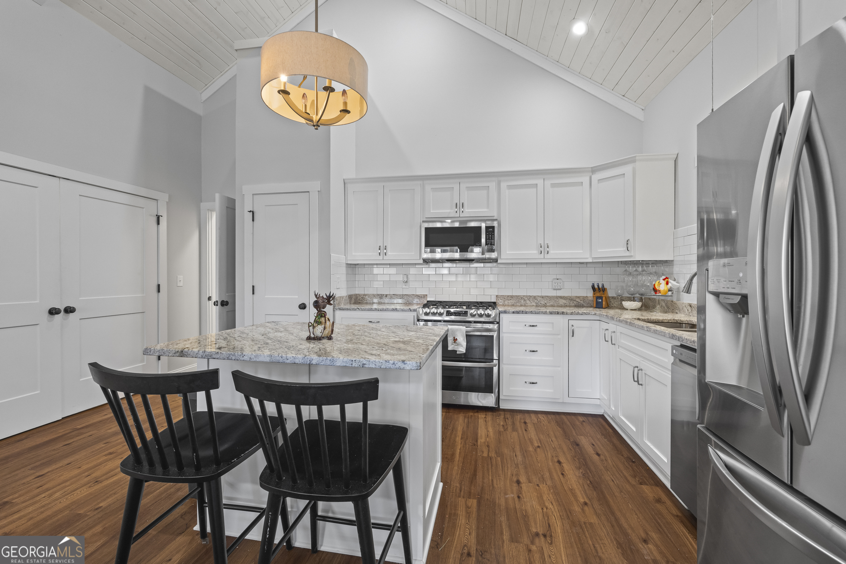 32 Shirleys Way Hartwell, GA 30643 - Photo 21 of 42 a kitchen with stainless steel appliances granite countertop a dining table chairs refrigerator and microwave