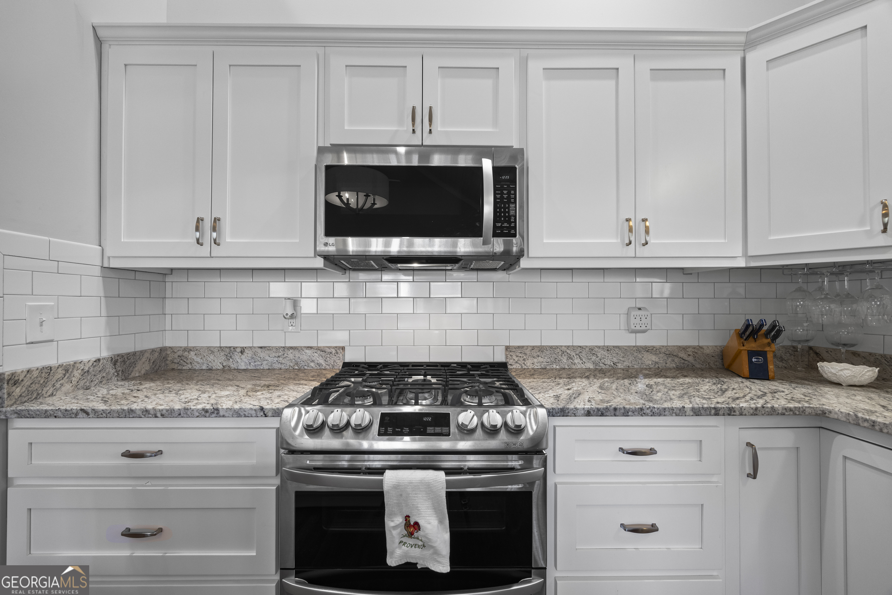 32 Shirleys Way Hartwell, GA 30643 - Photo 24 of 42 a kitchen with granite countertop white cabinets and a stove