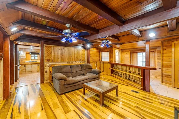 a dining room with furniture and a floor to ceiling window