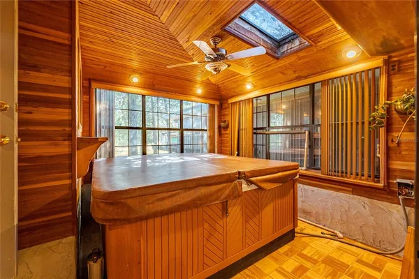 a view of a hallway with wooden walls and entryway