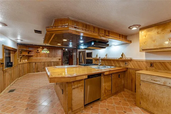 a kitchen with stainless steel appliances granite countertop a stove and a refrigerator