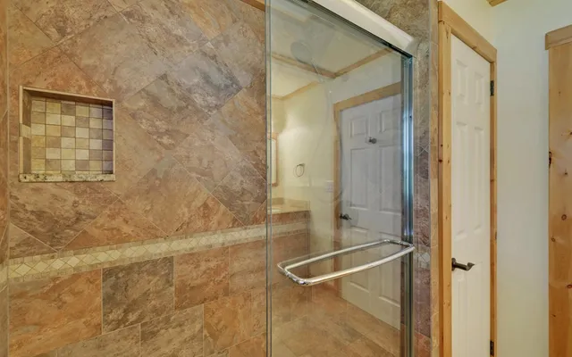 a bathroom with a glass shower door