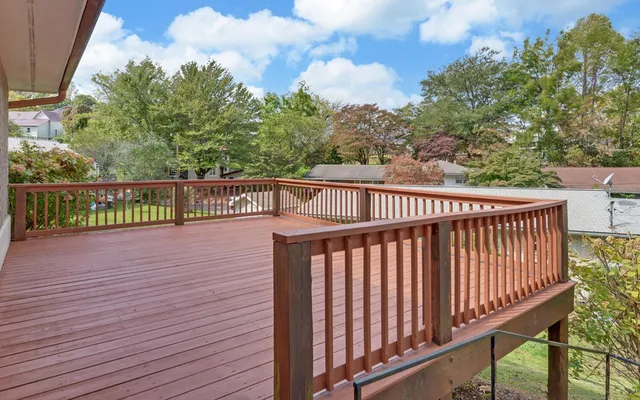 a view of balcony with wooden floor and fence