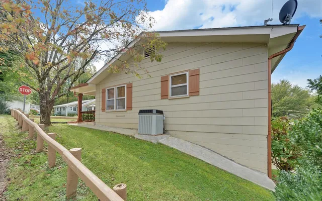 a view of a house with a yard and sitting area