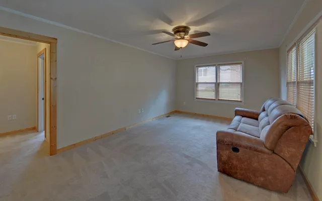 a living room with furniture and a chandelier