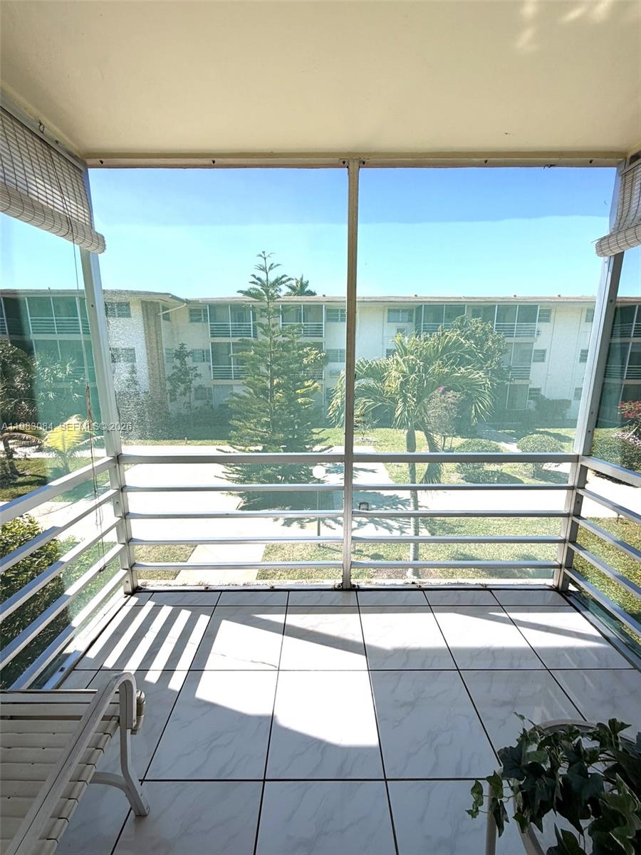 17000 Northeast 14th Avenue, Unit 206 Miami, FL 33162 - Photo 12 of 15 a view of a floor to ceiling window next to a yard