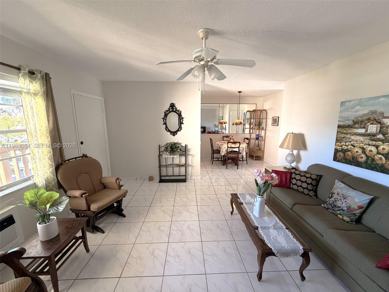 17000 Northeast 14th Avenue, Unit 206 Miami, FL 33162 - Photo 2 of 15 a living room with furniture and wooden floor