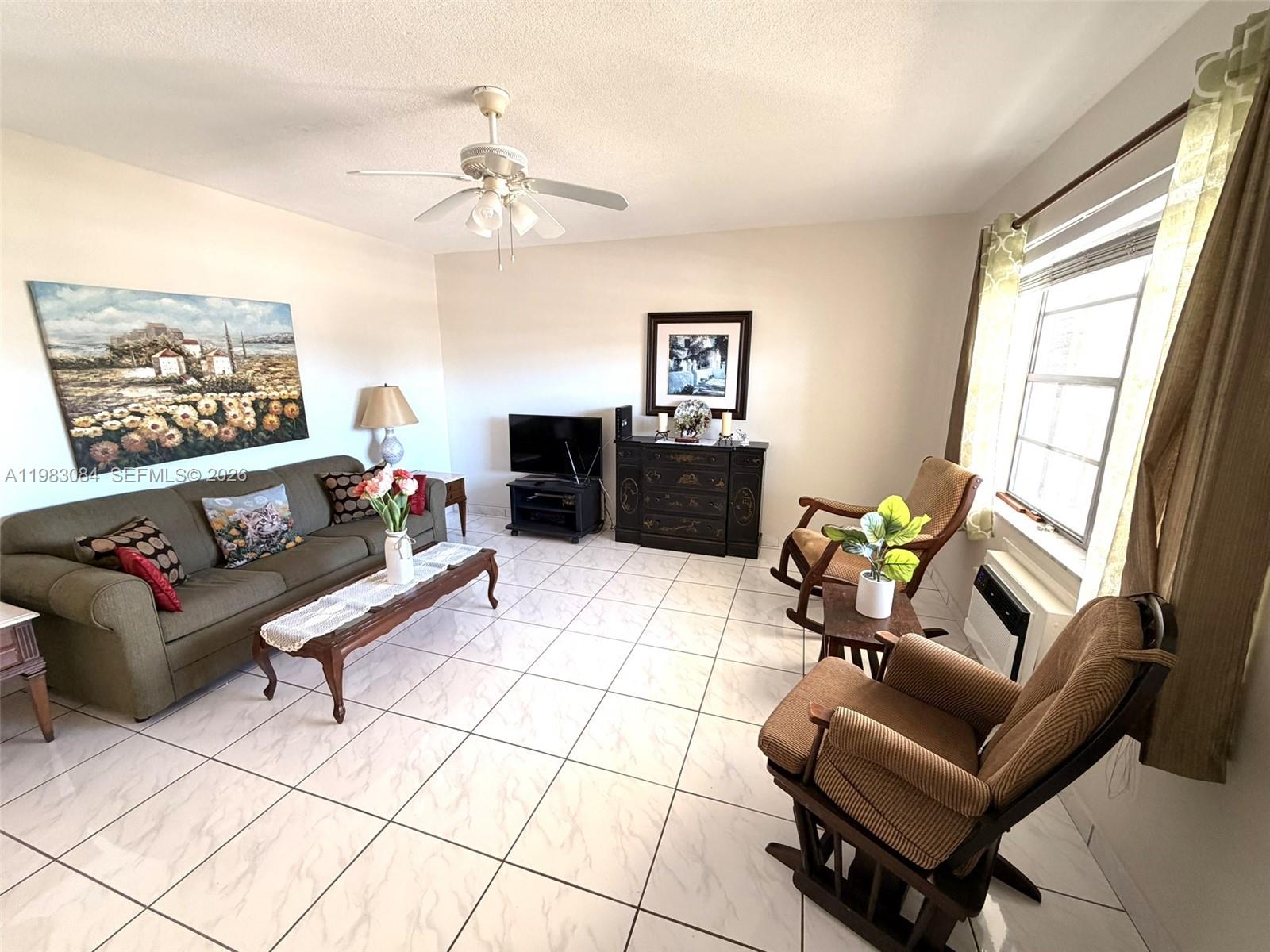 17000 Northeast 14th Avenue, Unit 206 Miami, FL 33162 - Photo 3 of 15 a living room with furniture and a flat screen tv