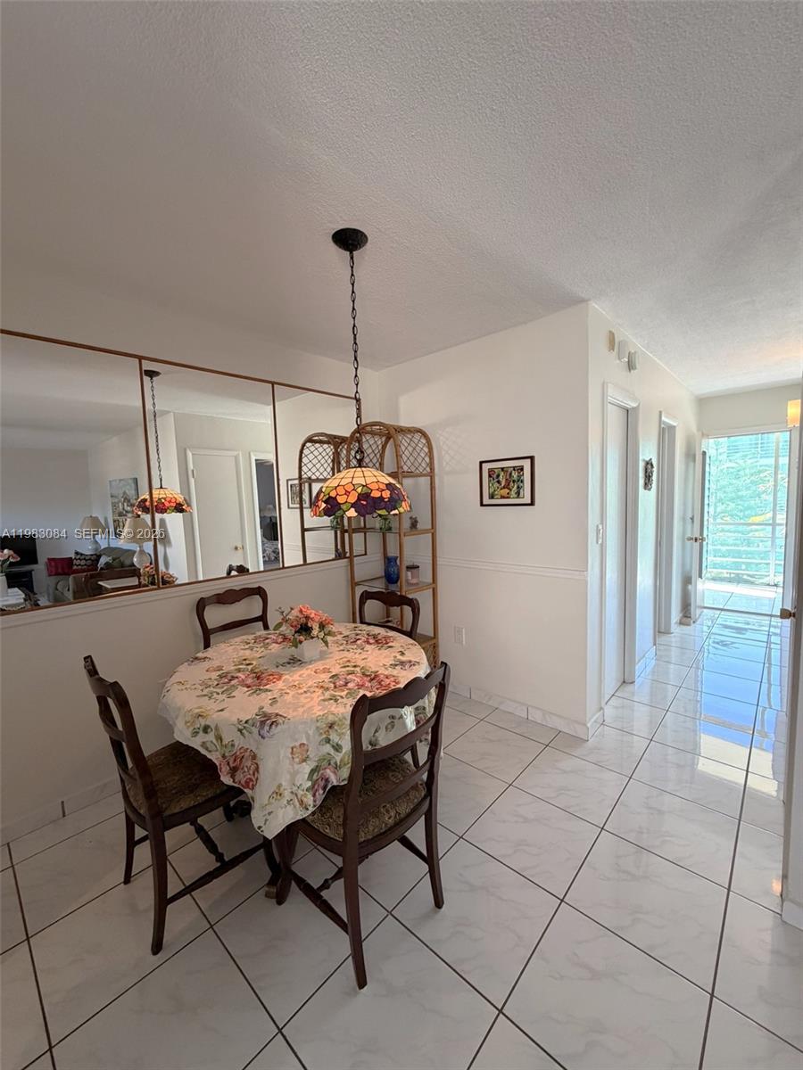17000 Northeast 14th Avenue, Unit 206 Miami, FL 33162 - Photo 4 of 15 a view of a dining room with furniture