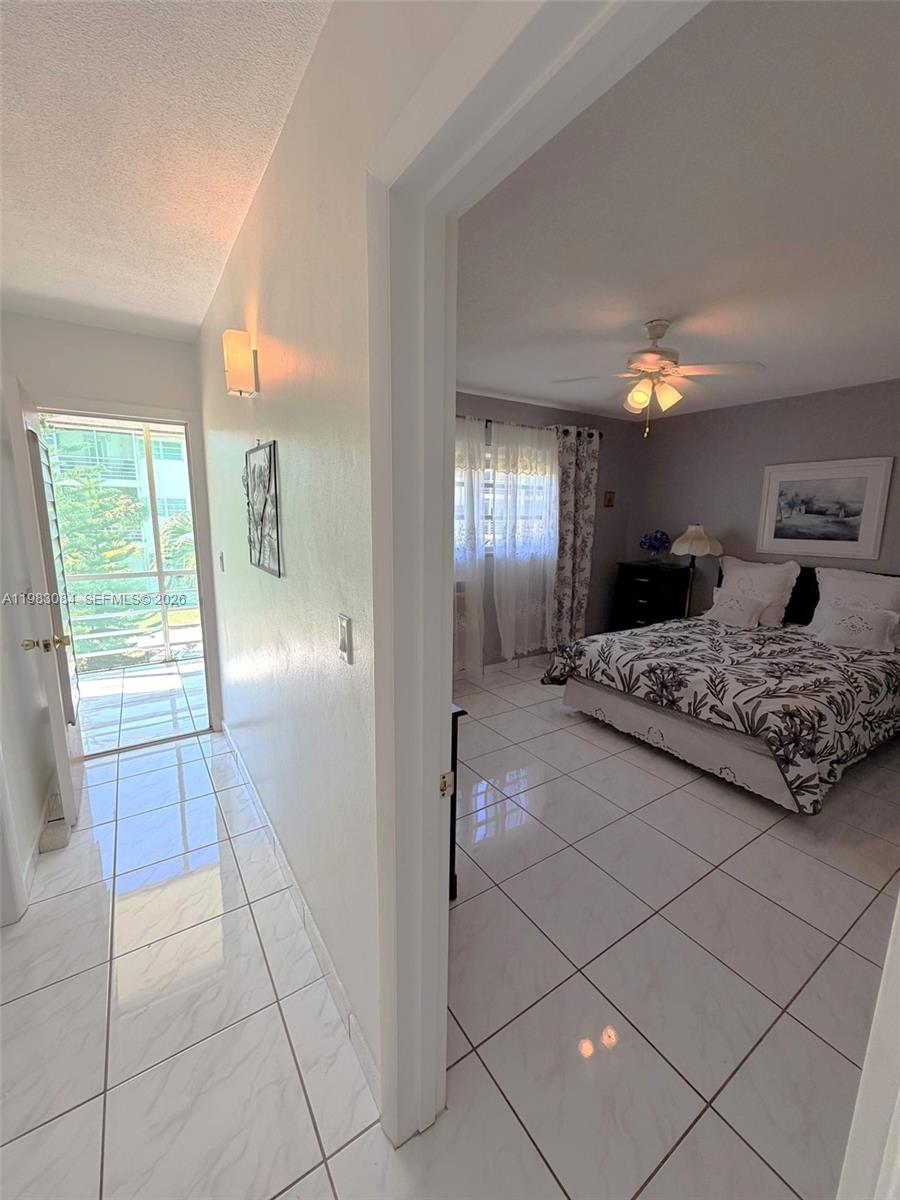 17000 Northeast 14th Avenue, Unit 206 Miami, FL 33162 - Photo 7 of 15 a large bedroom with a bed and a mirror