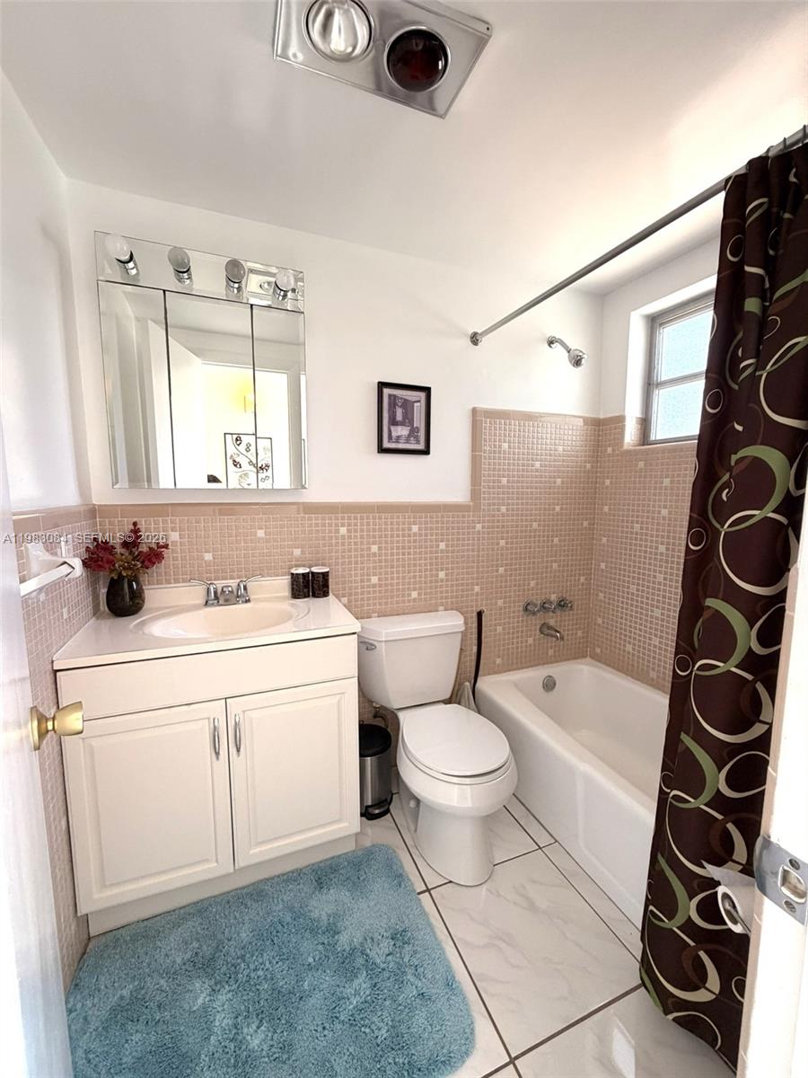 17000 Northeast 14th Avenue, Unit 206 Miami, FL 33162 - Photo 10 of 15 a bathroom with a sink a toilet and a bathtub