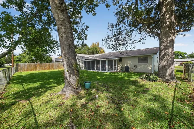 a view of house with a backyard