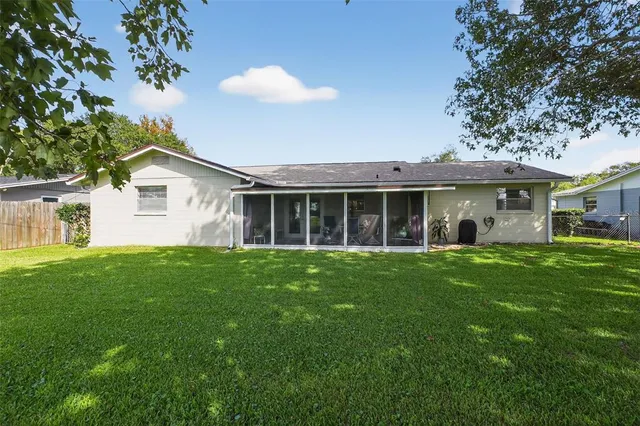 a view of a house with a backyard