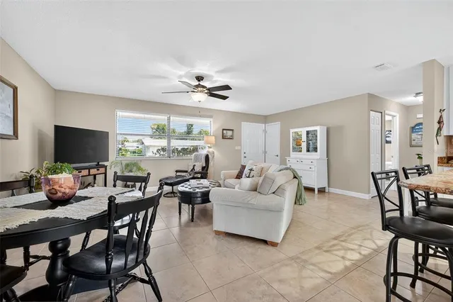 a living room with furniture a flat screen tv and a large window