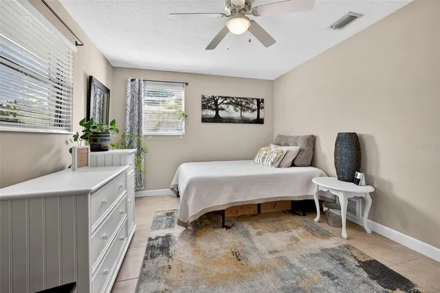 a spacious bedroom with a bed and a chandelier