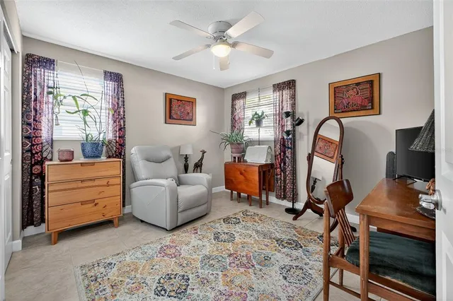 a living room with furniture a desk and chair with wooden floor