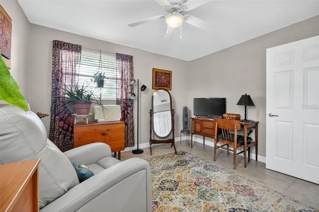 a living room with furniture a rug and a window