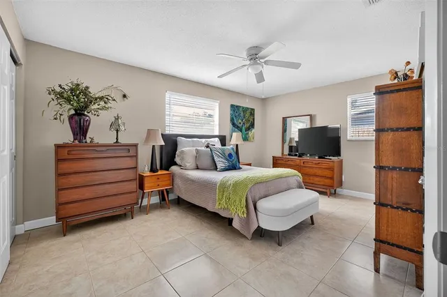a spacious bedroom with a bed and a chandelier