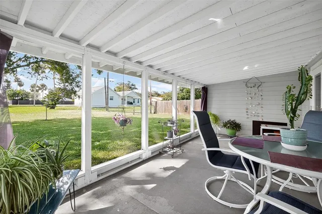 a dining room with furniture water view and a floor to ceiling window