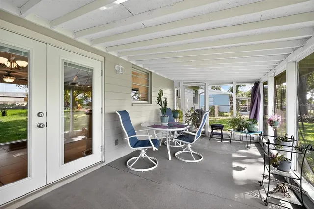 a dining room with furniture and a floor to ceiling window