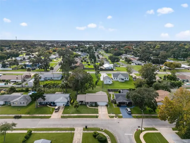an aerial view of residential houses with outdoor space and swimming pool