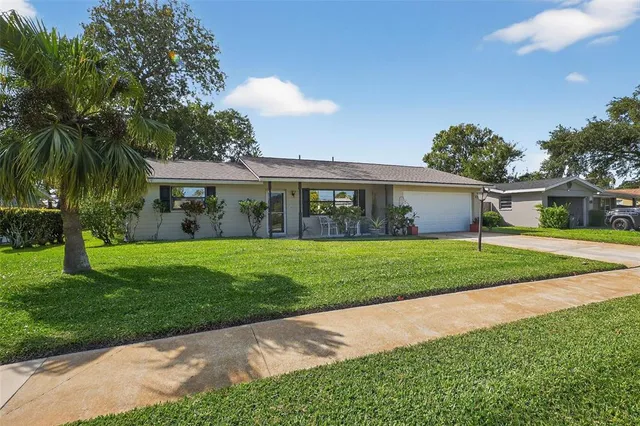 a view of house with a yard