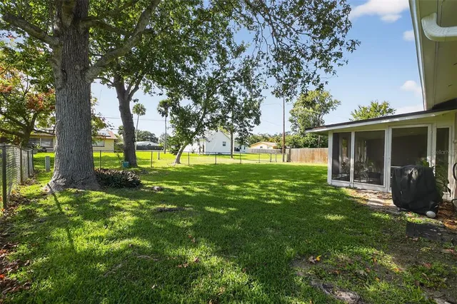 a view of a house with a backyard