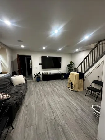 a view of a room with furniture and wooden floor
