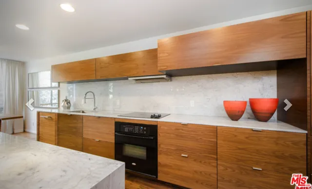 a kitchen with stainless steel appliances granite countertop wooden cabinets and sink