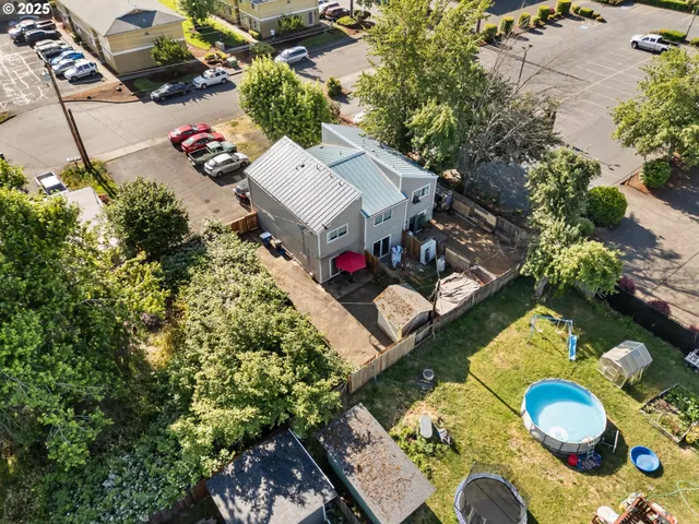 an aerial view of a house yard and a swimming pool