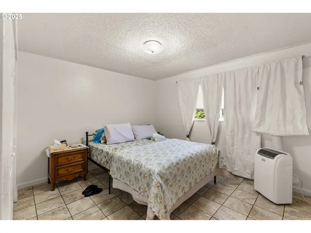 a bedroom with a bed and a view of bathroom