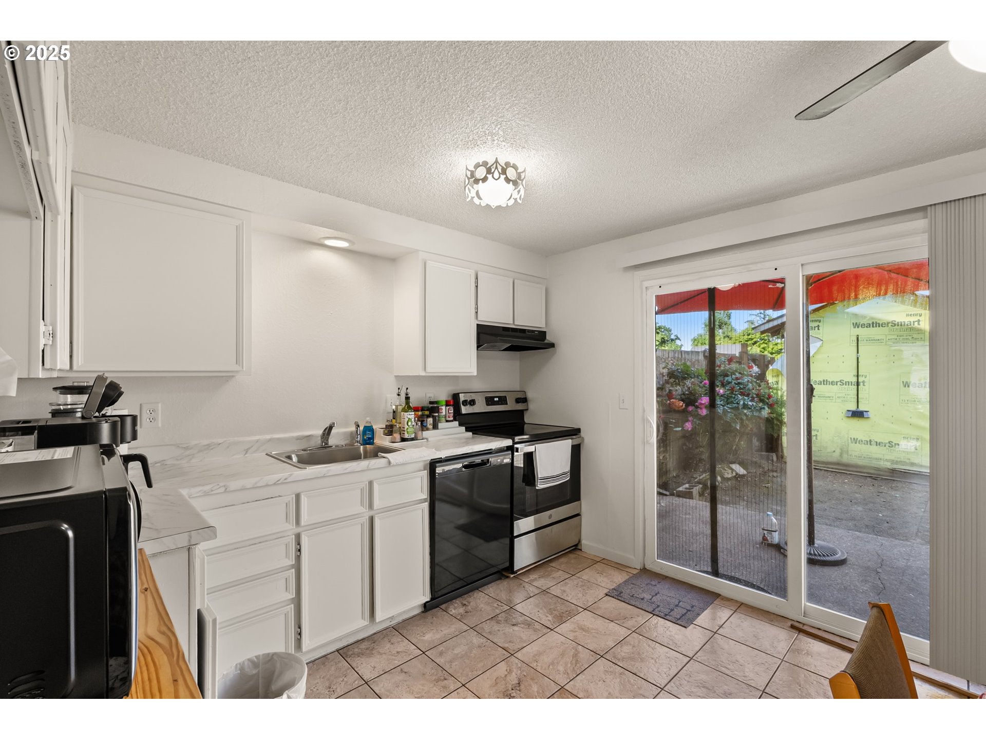 1720 17th Street Springfield, OR 97477 - Photo 10 of 23 a kitchen with a sink a counter top space and stainless steel appliances