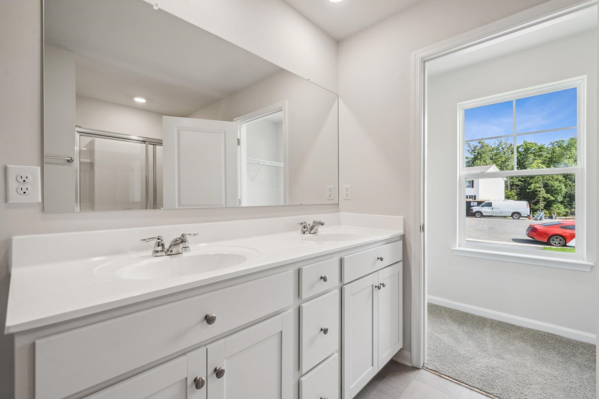 240 Waterfront Drive Raphine, VA 24472 - Photo 17 of 29 a bathroom with a double vanity sink mirror and next to a window