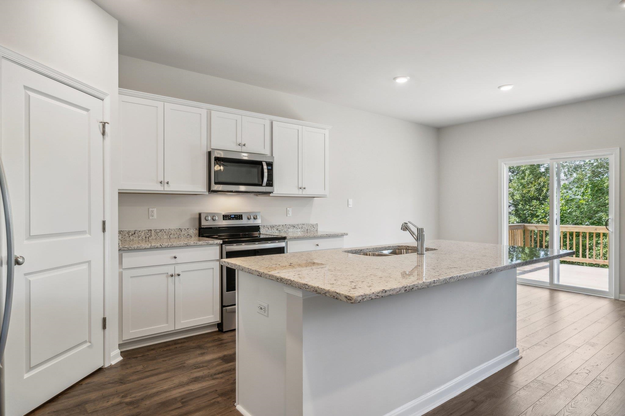 240 Waterfront Drive Raphine, VA 24472 - Photo 4 of 29 a kitchen with a sink stove and wooden floor