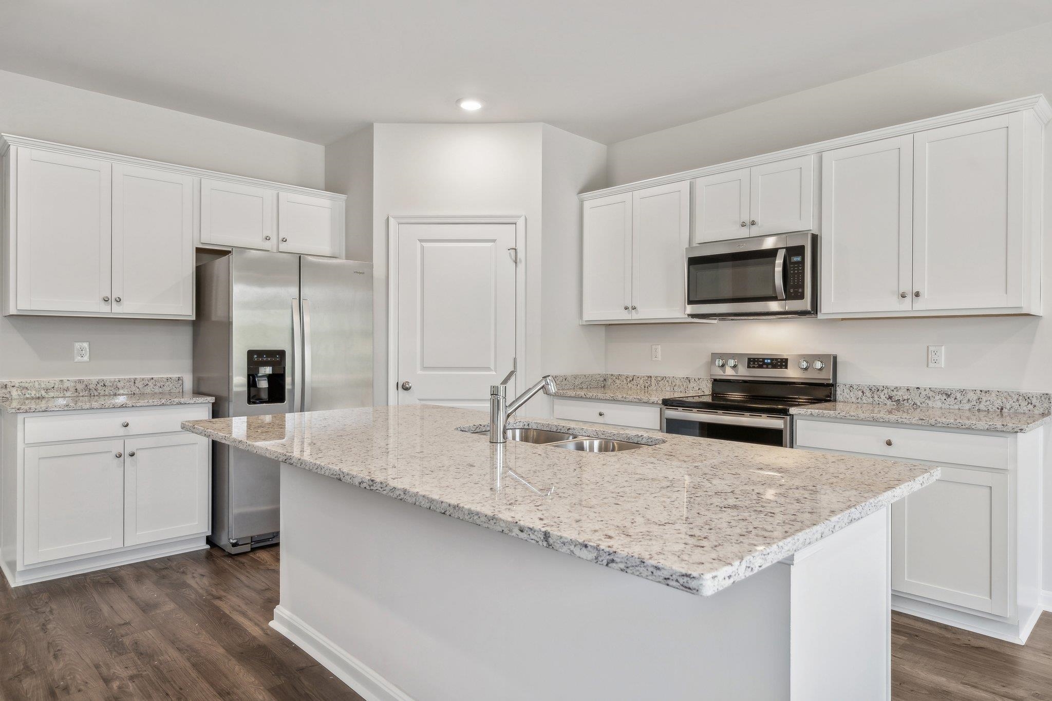 240 Waterfront Drive Raphine, VA 24472 - Photo 5 of 29 a kitchen with kitchen island granite countertop a sink stove microwave and refrigerator