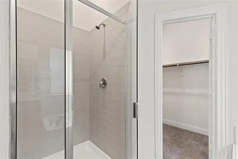 a bathroom with a glass shower door