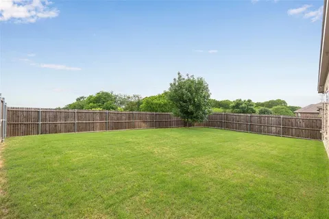 a view of a backyard with a fence