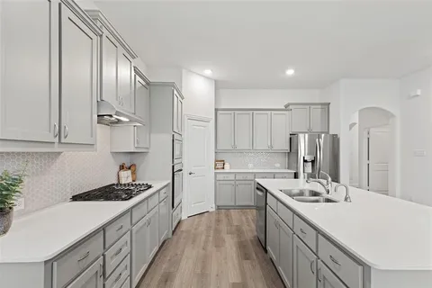 a kitchen with stainless steel appliances kitchen island granite countertop a lot of counter top space and cabinets