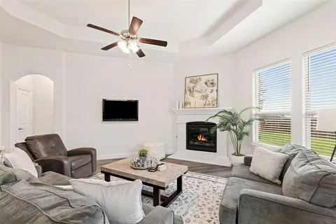 a living room with furniture a flat screen tv and a fireplace