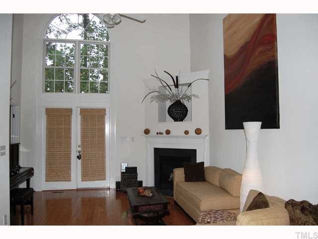 5306 Goldenglow Way Raleigh, NC 27606 - Photo 3 of 12 Stunning 2-story living room with attractive Palladium window, corner gas log fireplace with entertainment niche and plant shelf. Notice the gleaming hardwoods!