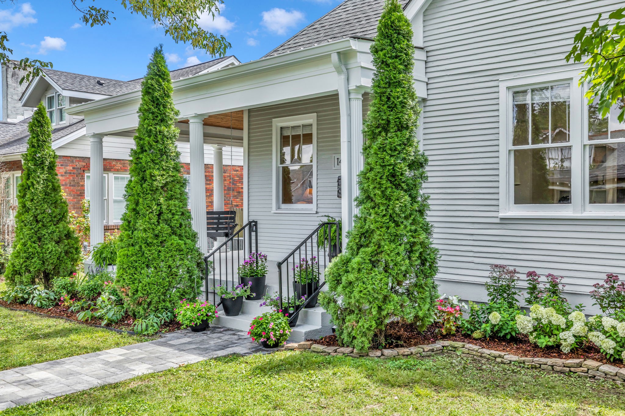 1412 Ordway Place Nashville, TN 37206 - Photo 4 of 70 a front view of a house with a yard and potted plants