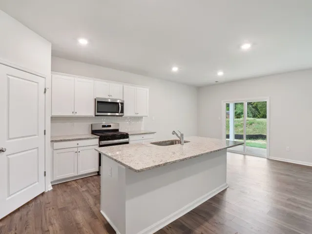 a kitchen with a sink stove and refrigerator
