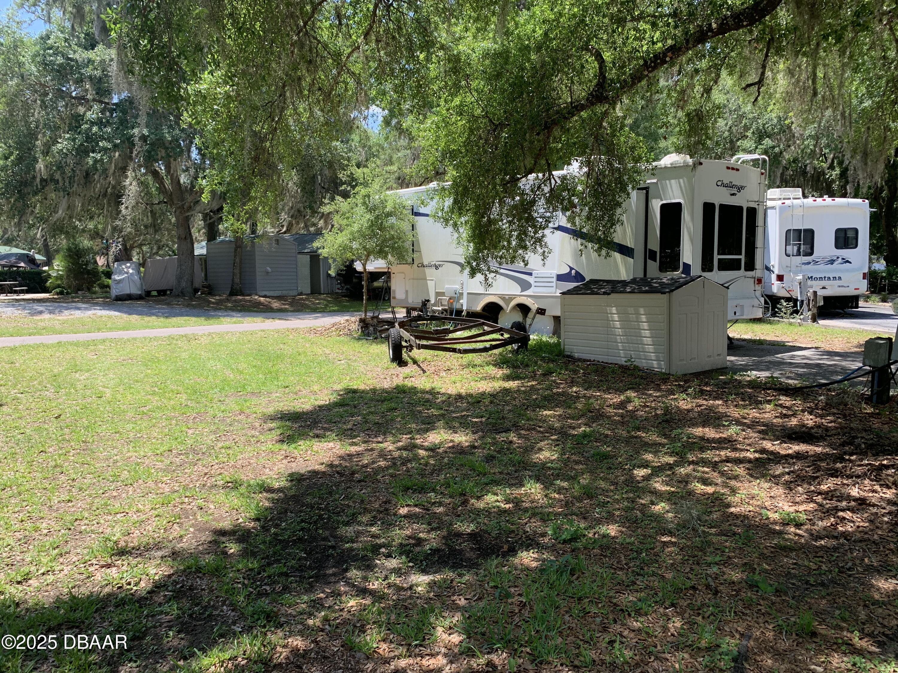 25145 Northeast 140th Loop Salt Springs, FL 32134 - Photo 1 of 48 a view of a swimming pool with lounge chair