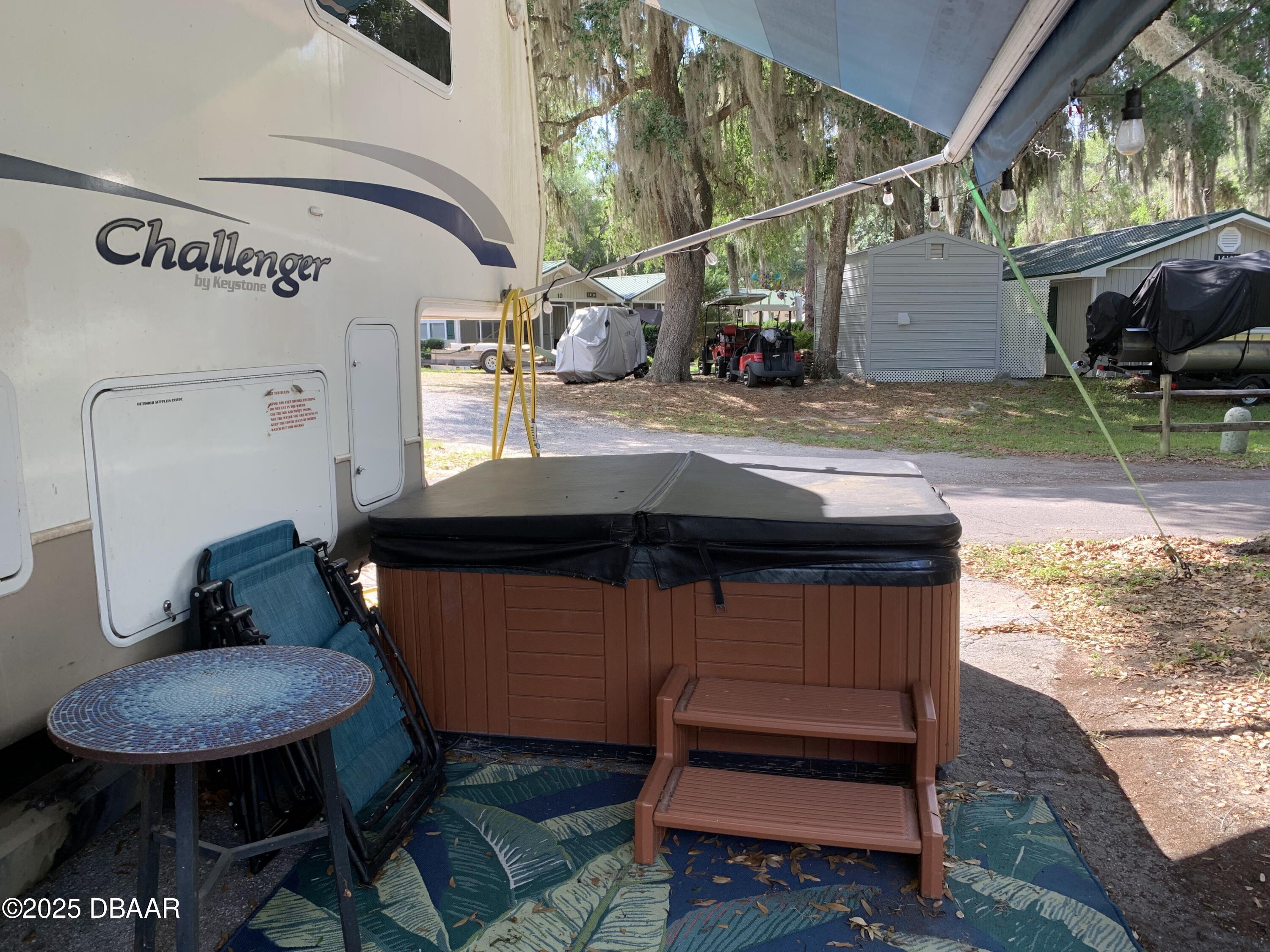 25145 Northeast 140th Loop Salt Springs, FL 32134 - Photo 4 of 48 a view of a patio with table and chairs with wooden floor and fence