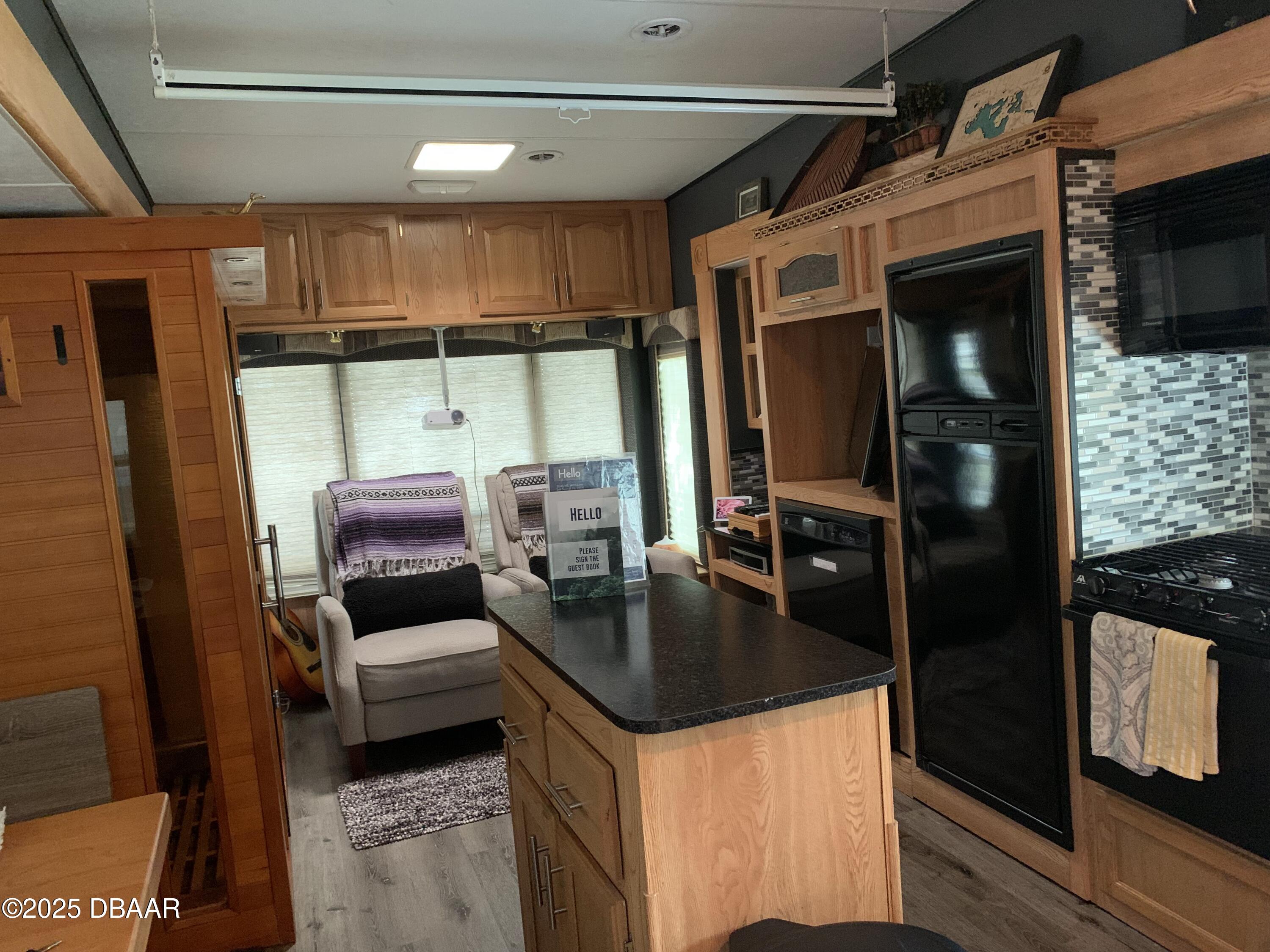 25145 Northeast 140th Loop Salt Springs, FL 32134 - Photo 5 of 48 a kitchen with stainless steel appliances granite countertop a sink and a refrigerator
