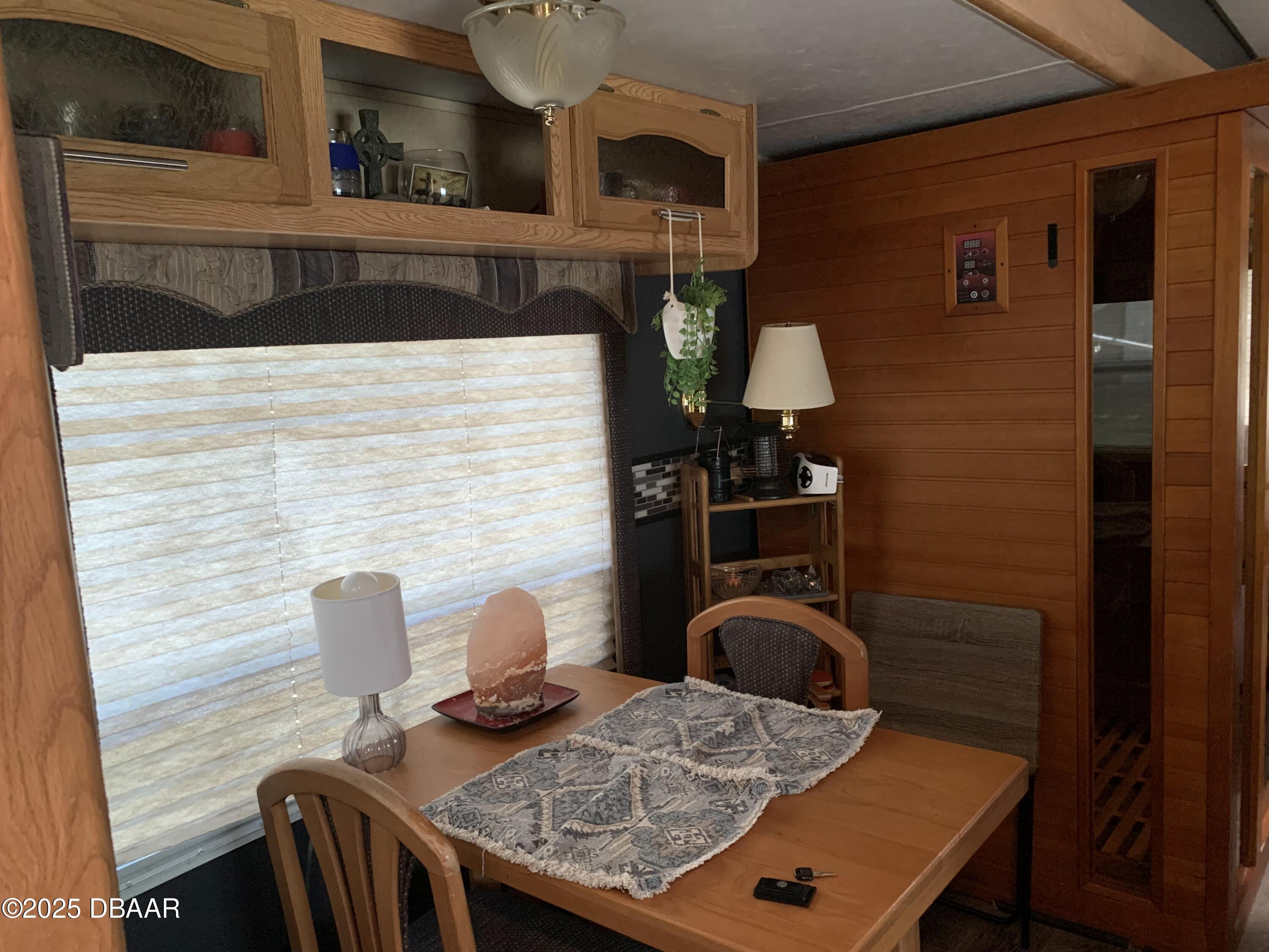 25145 Northeast 140th Loop Salt Springs, FL 32134 - Photo 8 of 48 a view of table chair and glass door